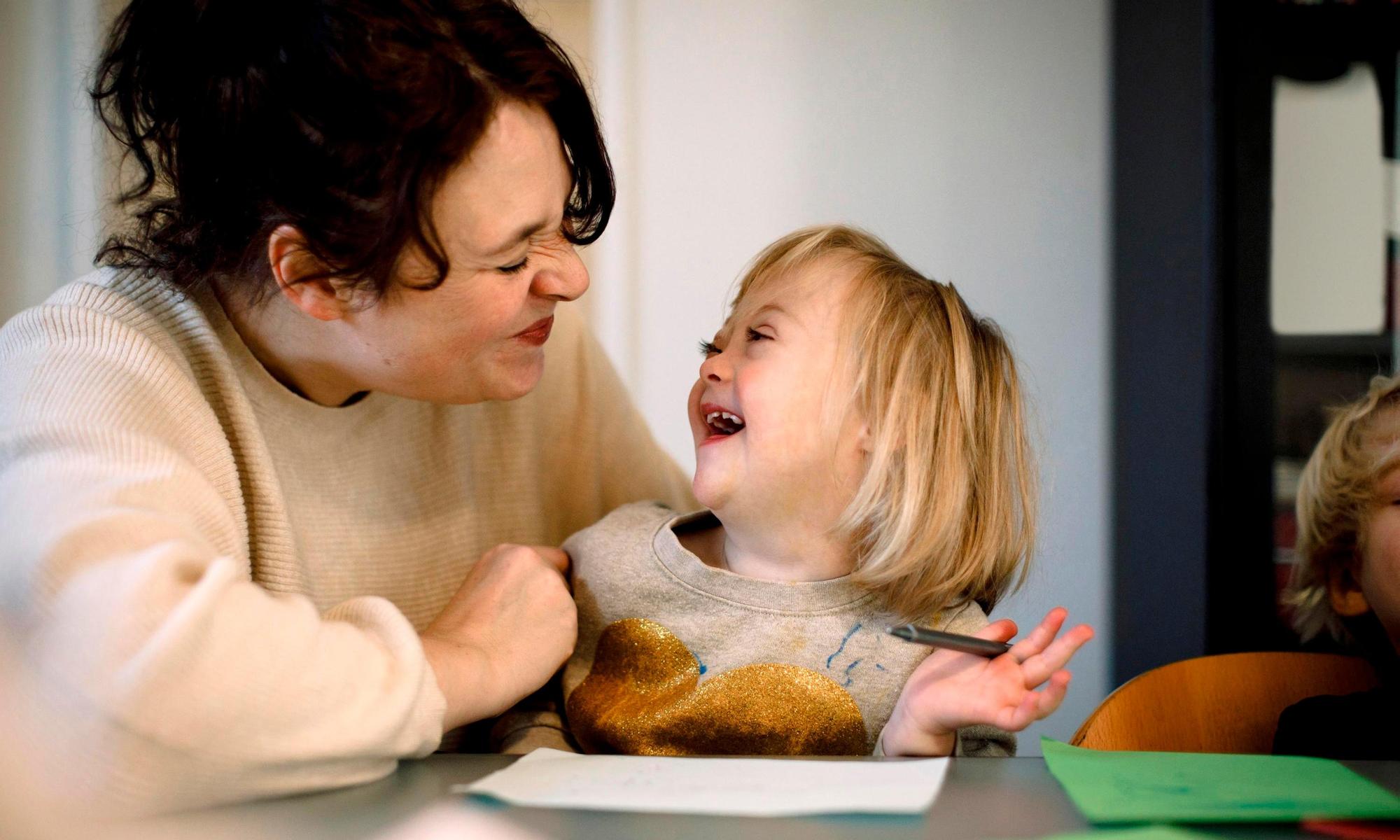 Mother and daughter crafting in the kitchen